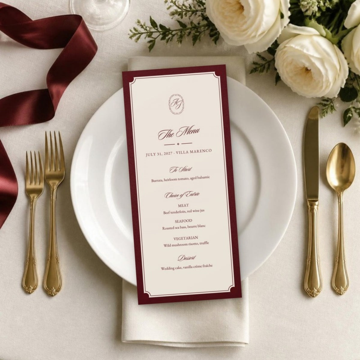 Wedding menu card on a white plate with gold flatware and white roses