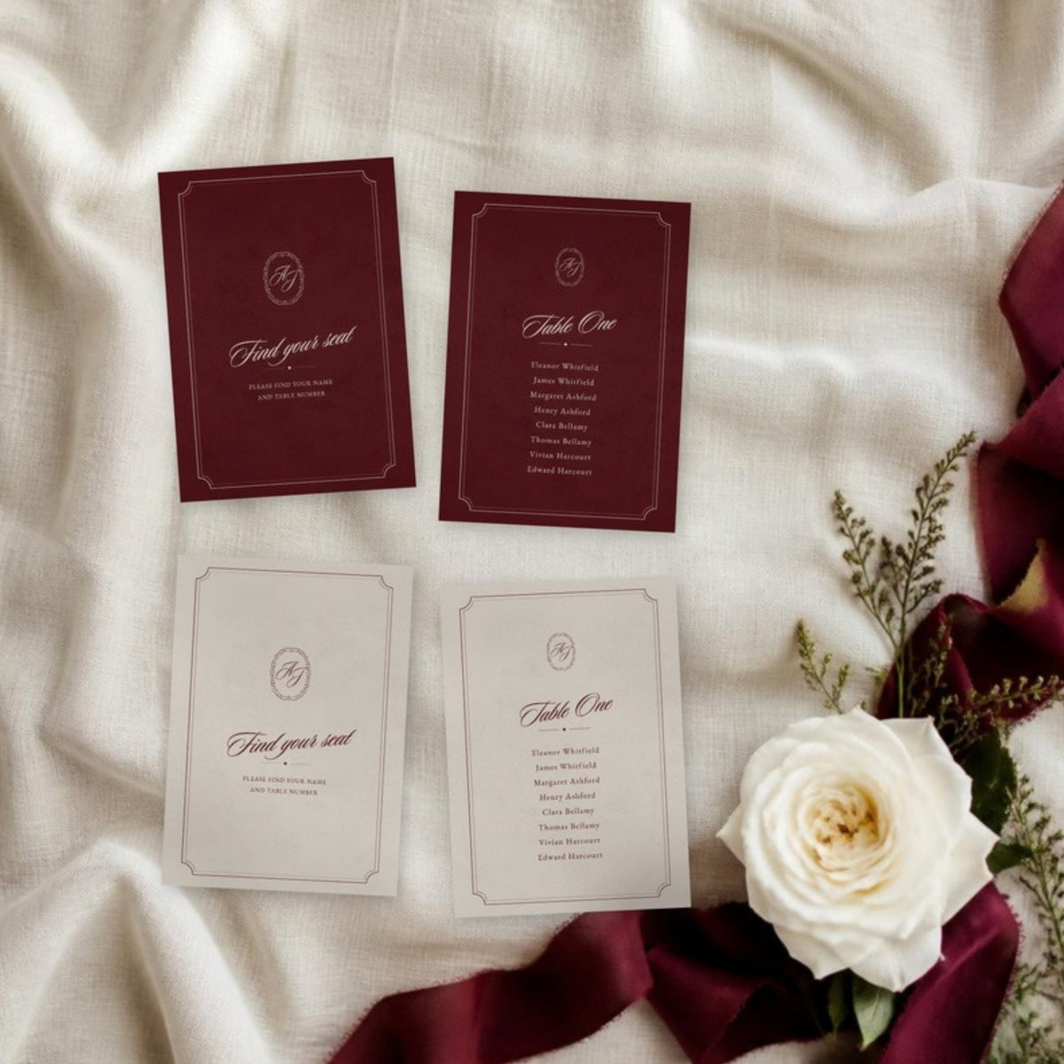 Burgundy and ivory find your seat and table cards on linen with a rose
