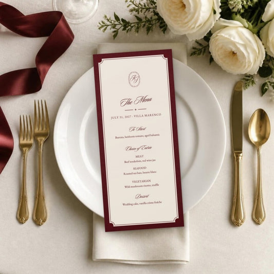 Wedding menu card on a white plate with gold flatware and white roses