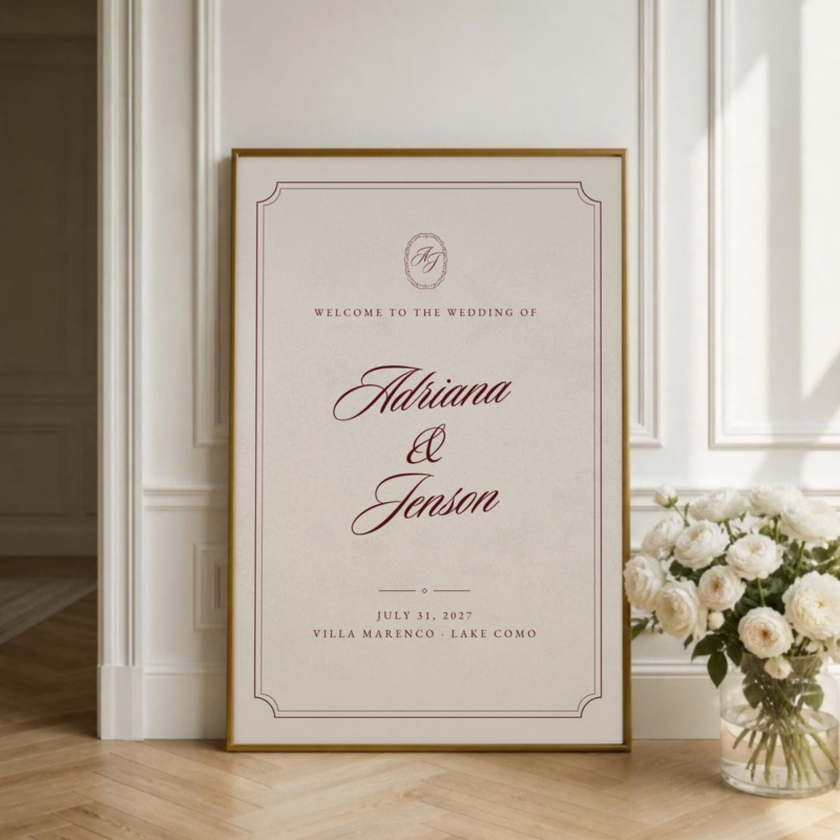 Ivory welcome sign in a gold frame leaning against a paneled wall